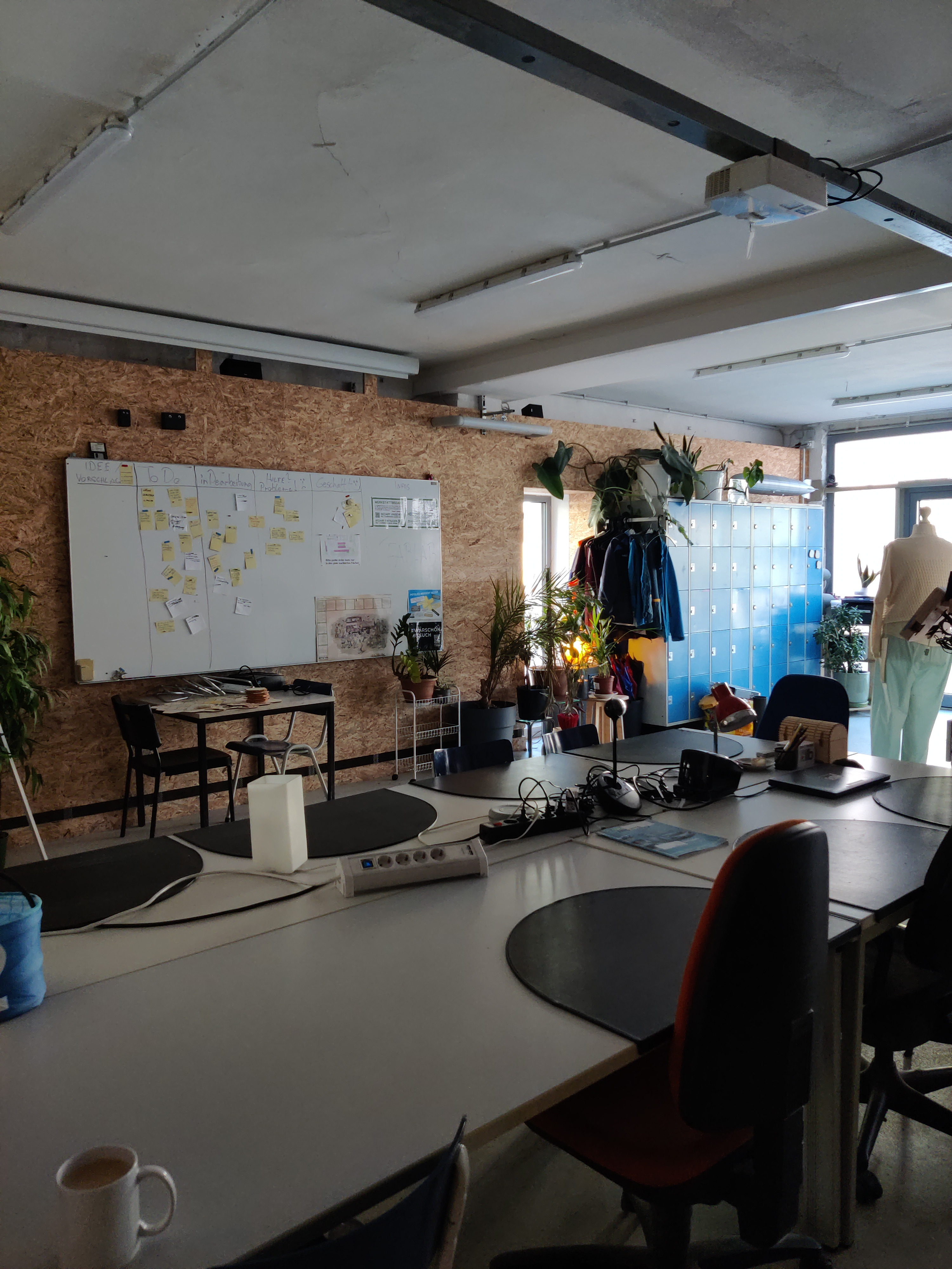 Tables, chairs, blackboard, screen, projector, speakers, and more